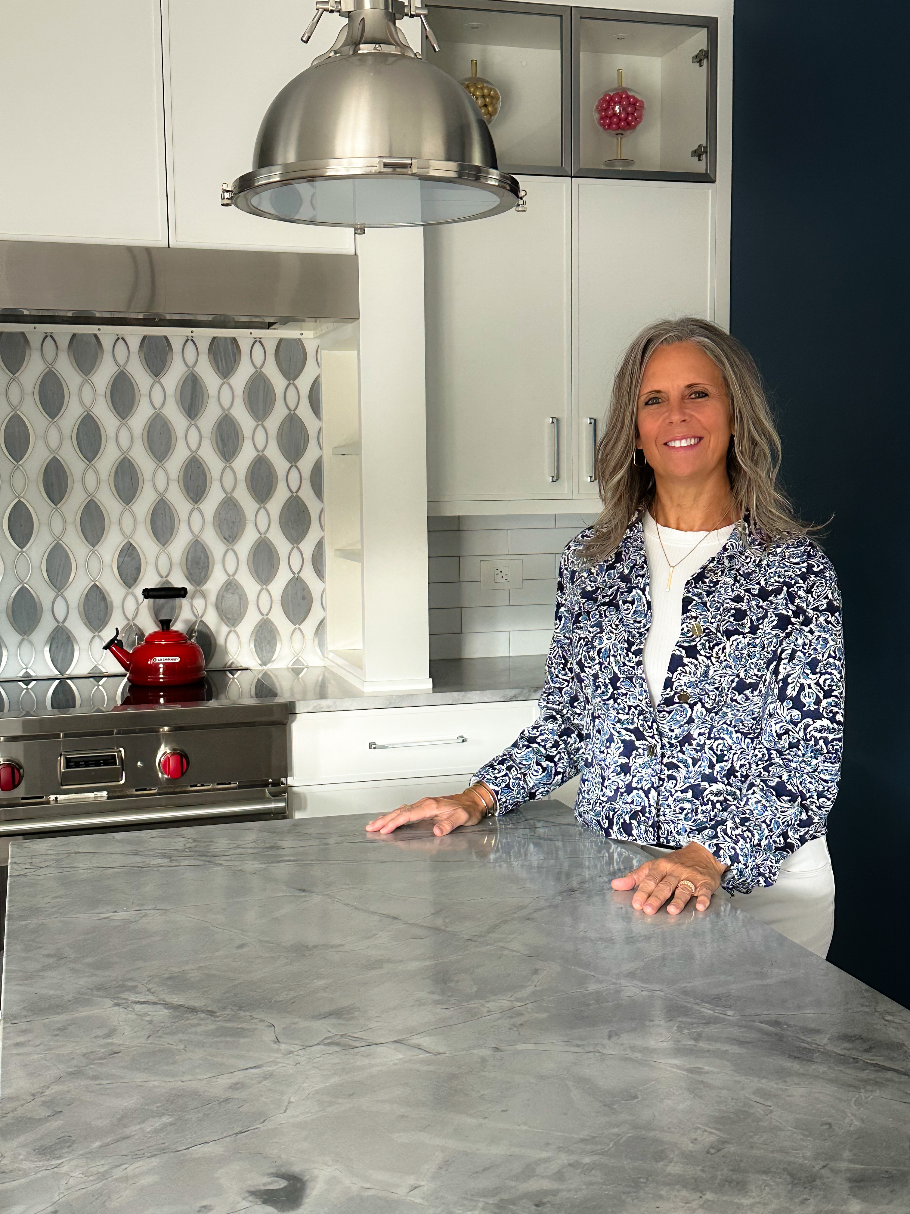 Kelly standing in her kitchen.