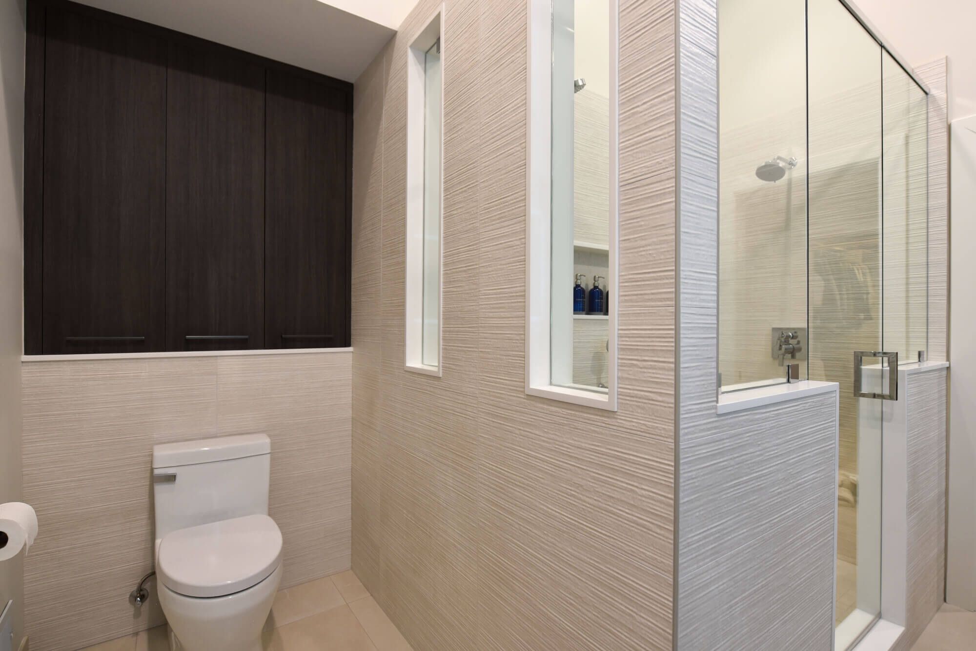 Custom cabinetry with storage above commode - Northwest Suburbs bathroom remodel by Kelly Thayer Design