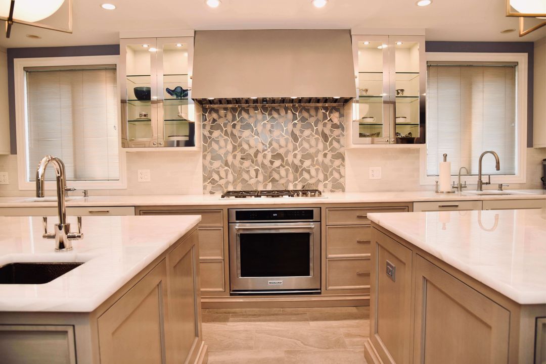 Inset cabinetry with polished metal range hood - North Shore kitchen design by Kelly Thayer