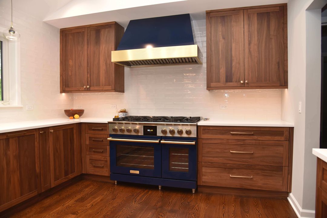 Frameless walnut cabinetry with Blue Star range - North Shore Chicago kitchen design by Kelly Thayer