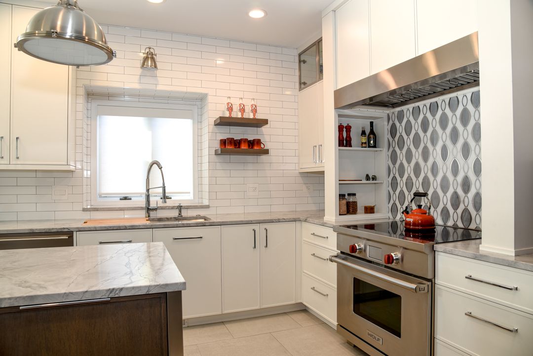 White shaker kitchen with matching wood range hood - Northwest Suburbs kitchen design by Kelly Thayer Design