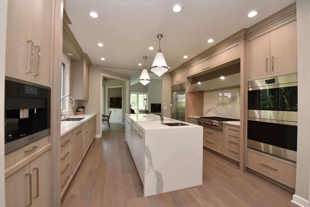 Inset cabinets with porcelain waterfall countertop - Northbrook remodel by Kelly Thayer