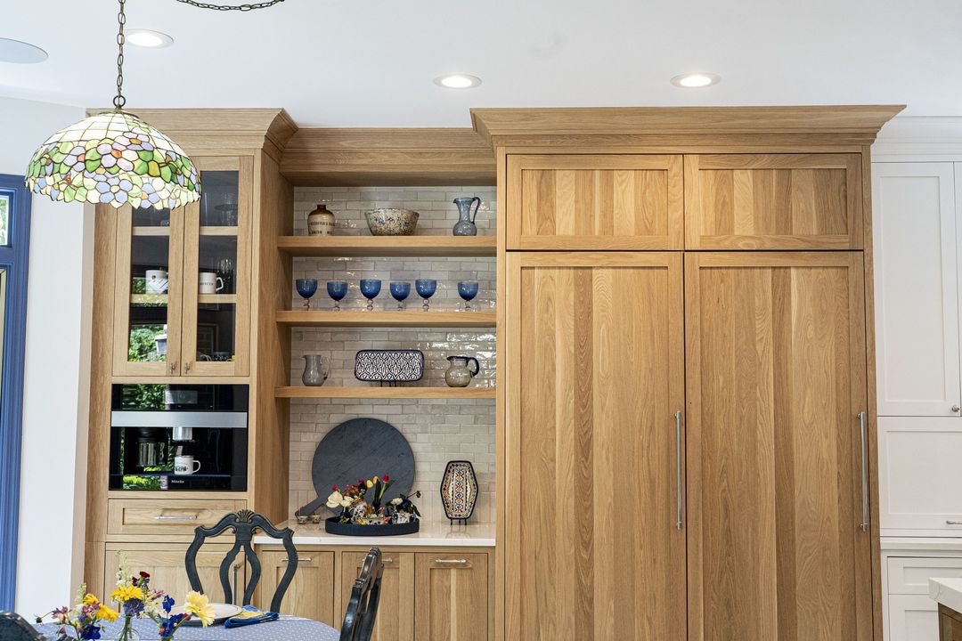 Winnetka coffee station with natural oak cabinetry, built-in Meile coffee maker, open shelving, paneled Sub-Zero columns, and zellige tile backsplash