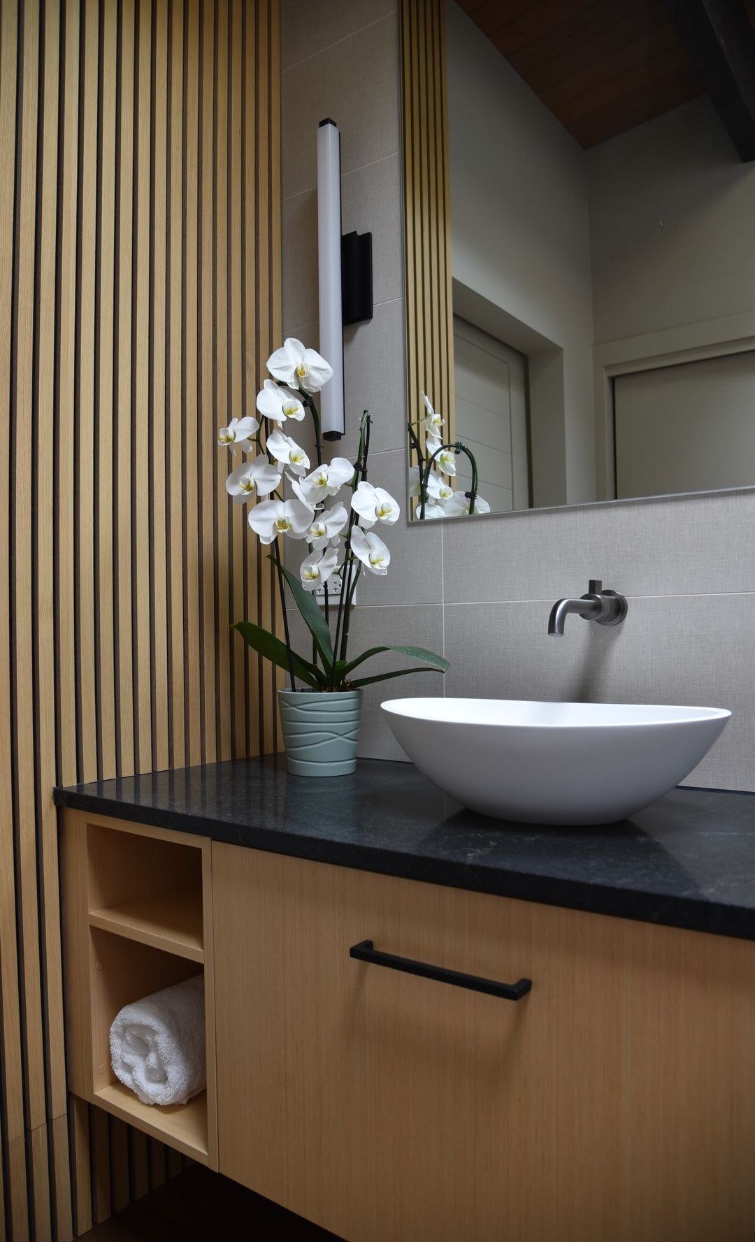 Riverwoods bathroom with wood floating vanity, vessel sink, and vertical wood slat accent wall – Kelly Thayer Design