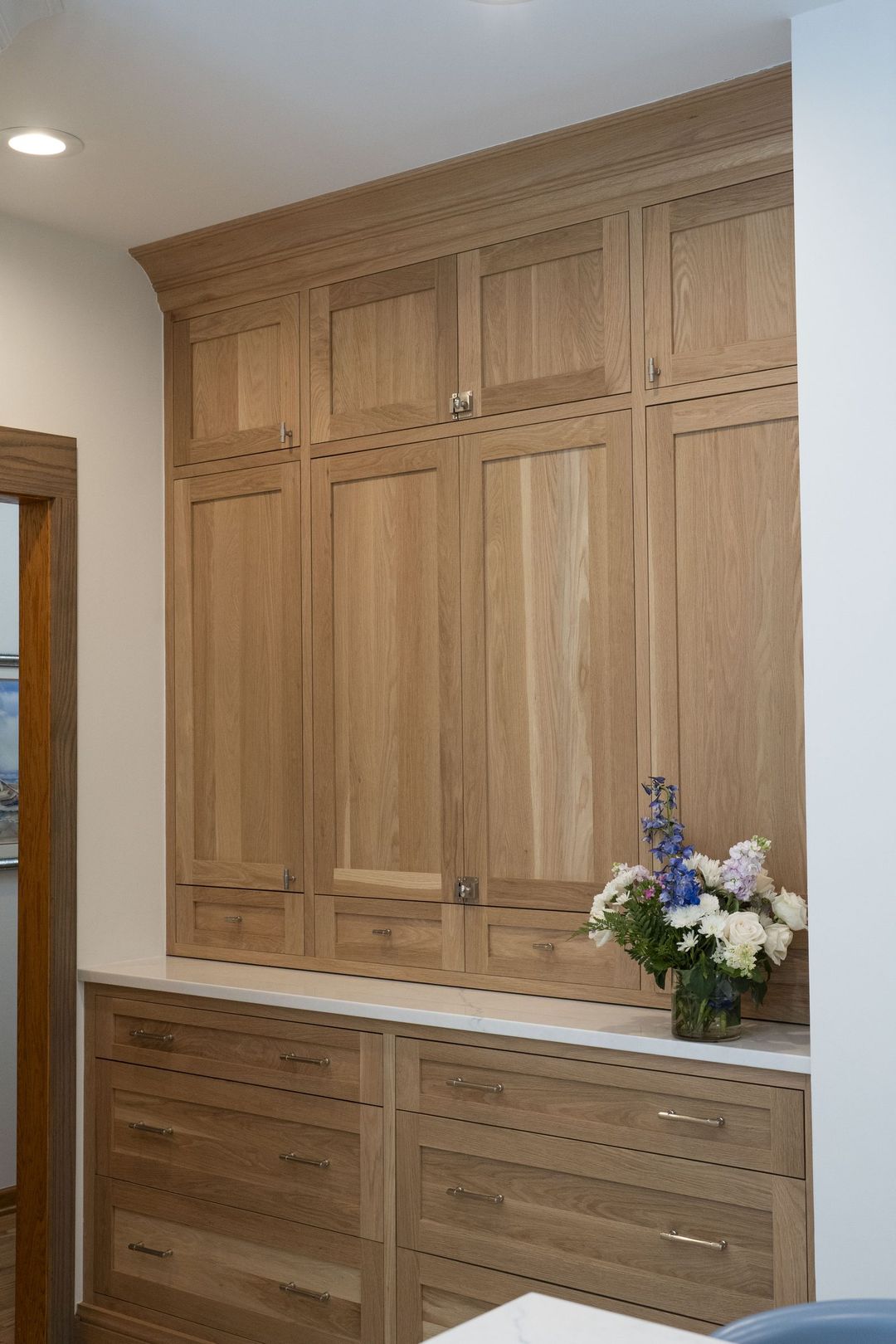 Winnetka custom butler's pantry storage with floor-to-ceiling natural oak lockers, shaker drawers, and quartz countertop - Kelly Thayer Design