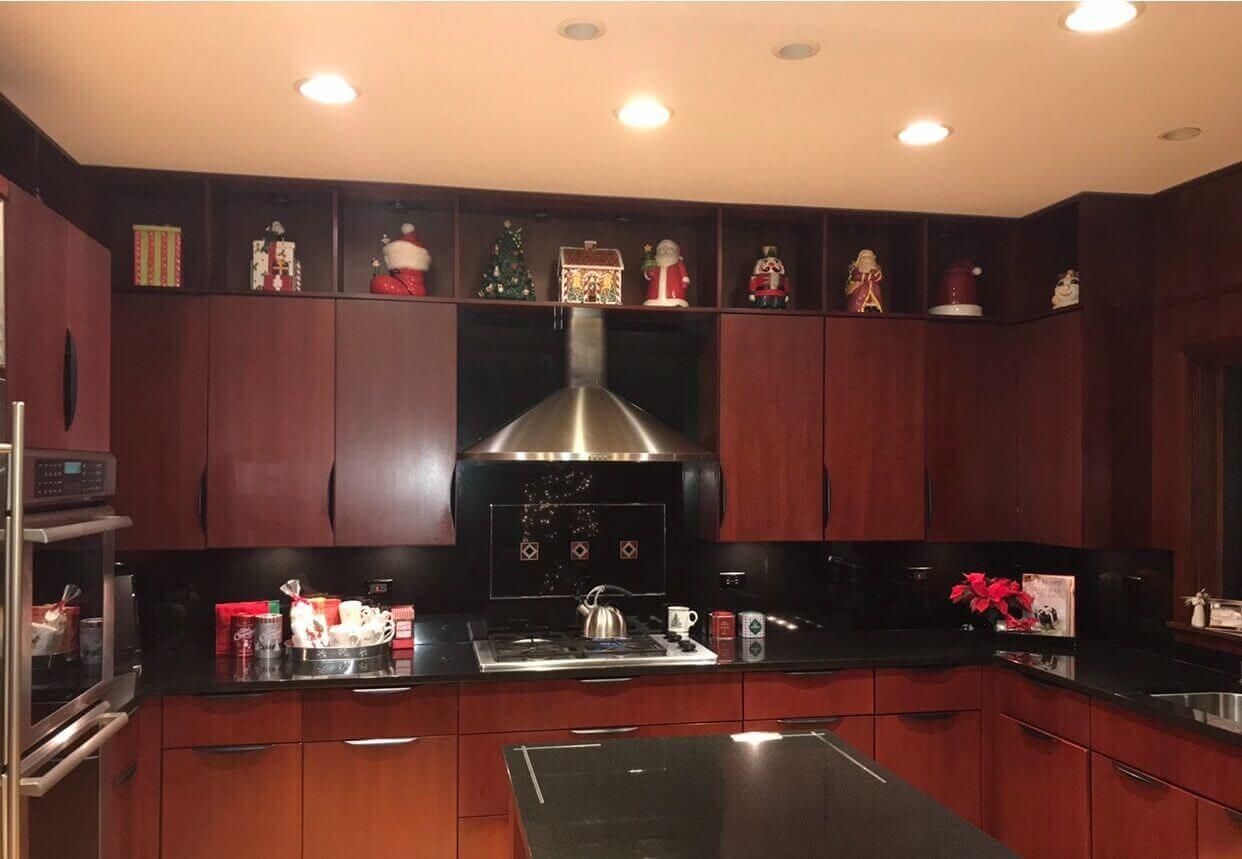 Northbrook completed kitchen renovation | Kelly Thayer Design Before photo of Kildeer kitchen remodel: dark cherry flat-panel cabinets with black granite countertops and full-height backsplash