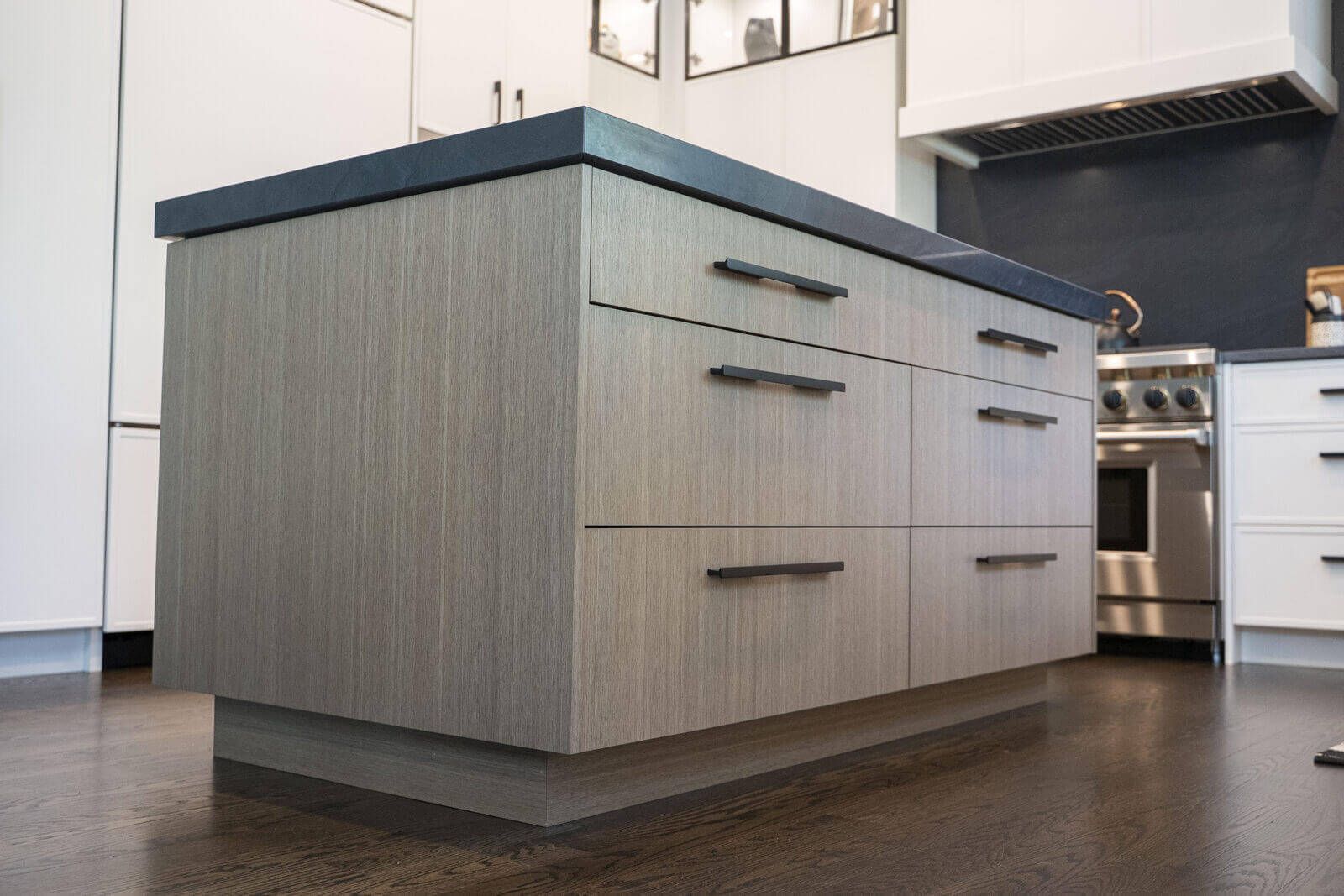 Northbrook Kitchen Remodel - Hidden Storage | Kelly Thayer Design Rift-cut oak flat slab kitchen island with matte black hardware in Kildeer kitchen remodel