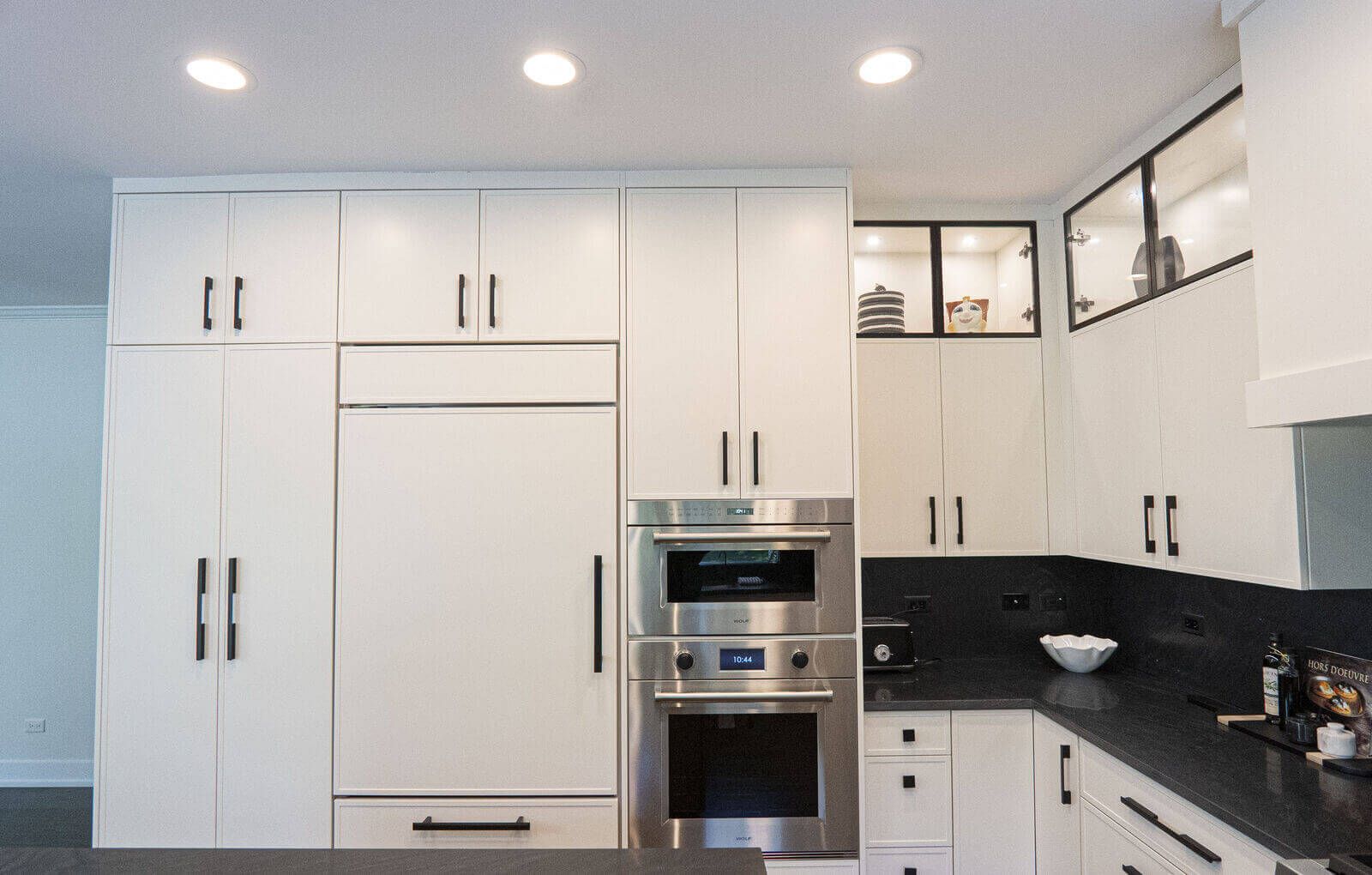 Northbrook Kitchen Remodel - Hidden Storage | Kelly Thayer Design Paneled Sub-Zero refrigerator with Wolf wall oven and microwave in white cabinetry wall — Kildeer kitchen designer