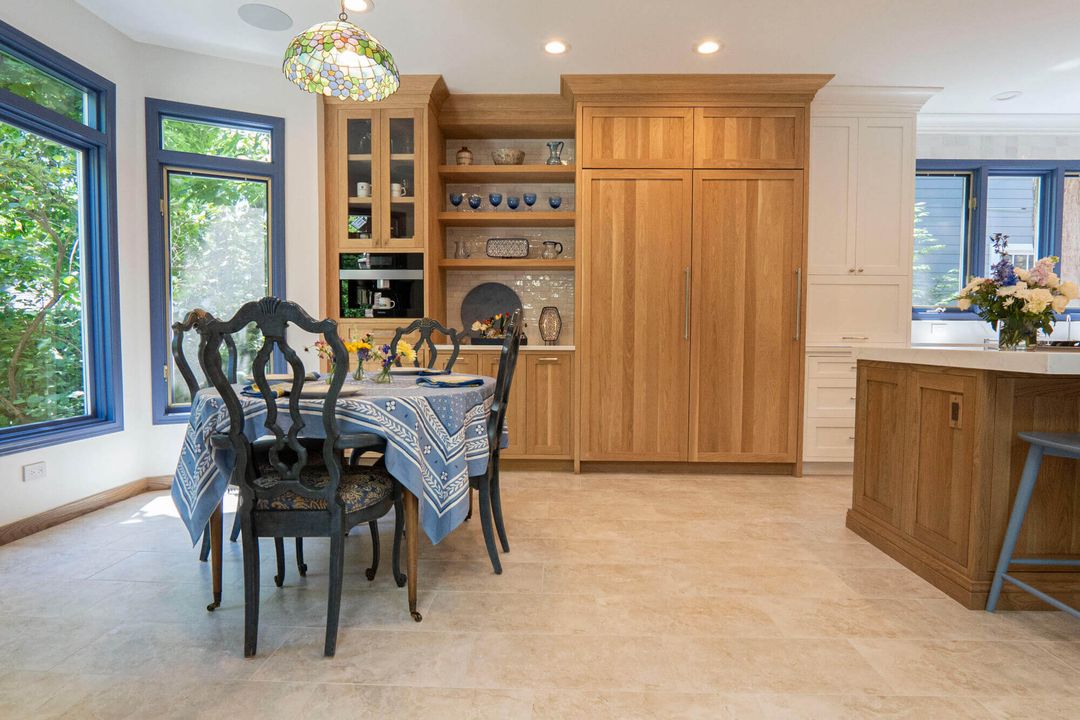 Winnetka kitchen remodel with white oak coffee center, blue-trimmed windows, and breakfast dining area